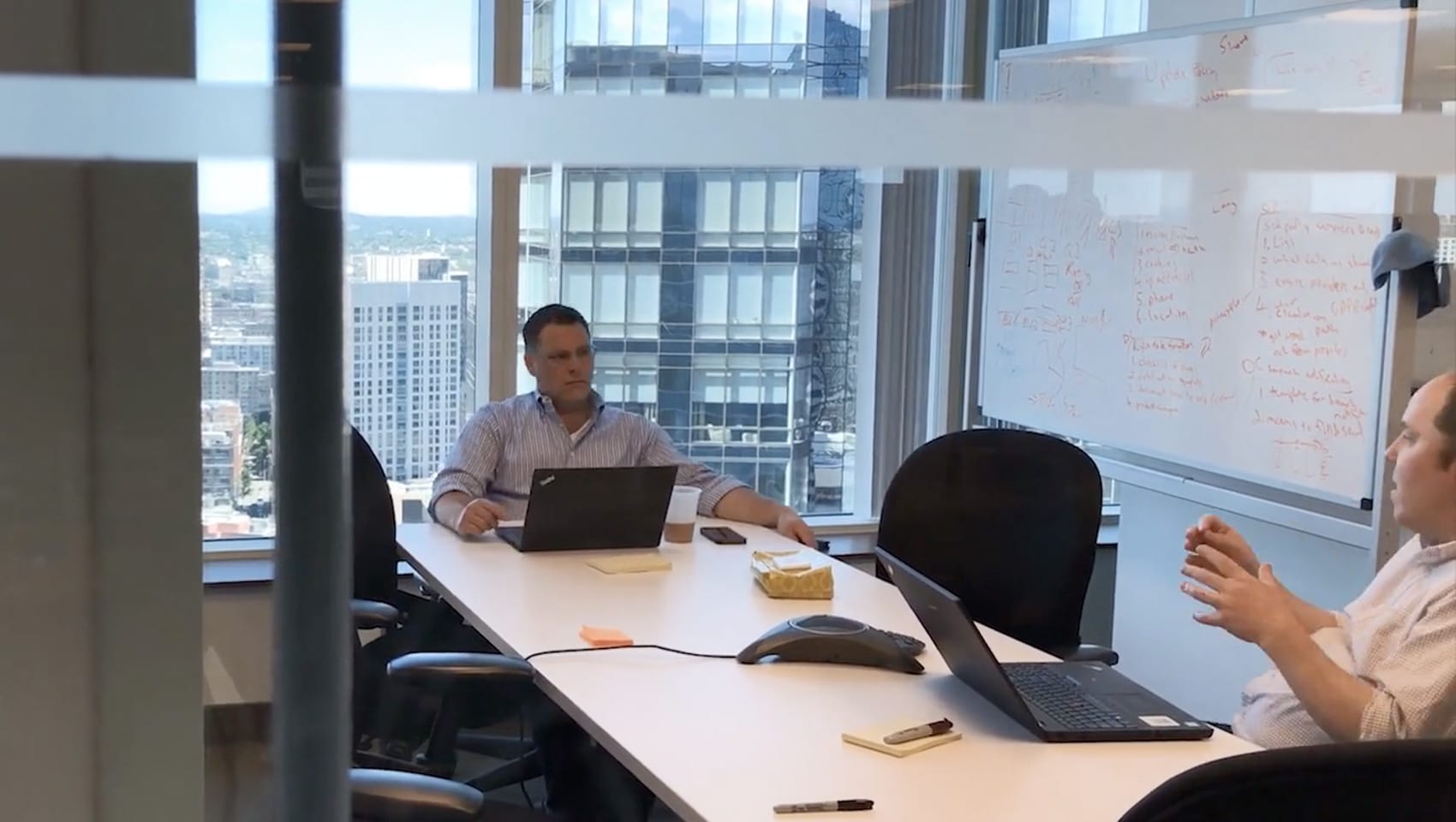 Two men sitting inside of the Building Engines office