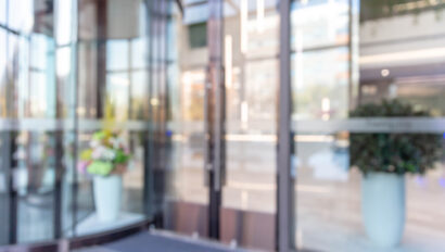 Defocused background effect of revolving doors at the entrance of a building