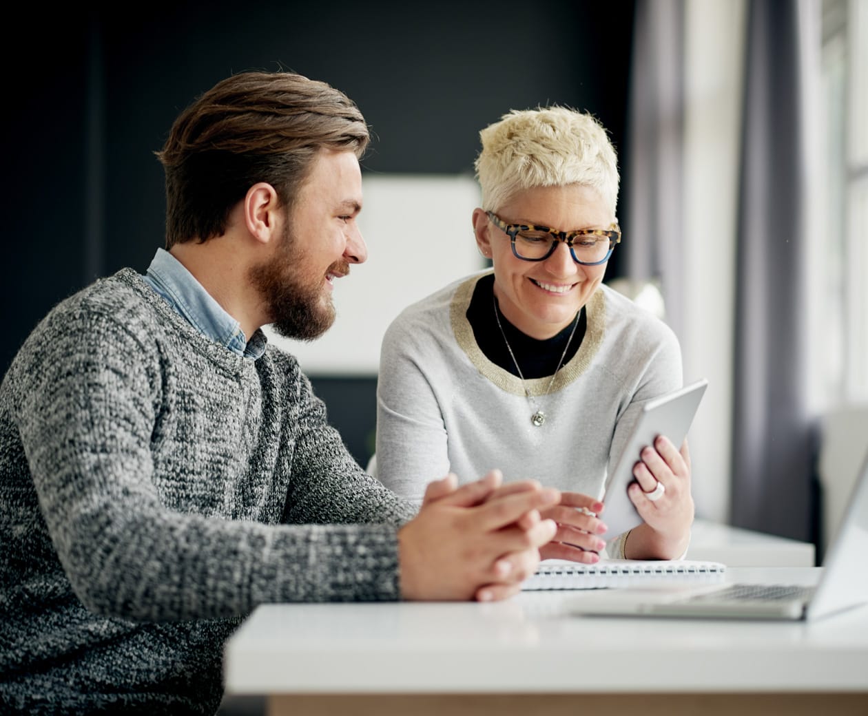 Male and female looking at Prism on a tablet