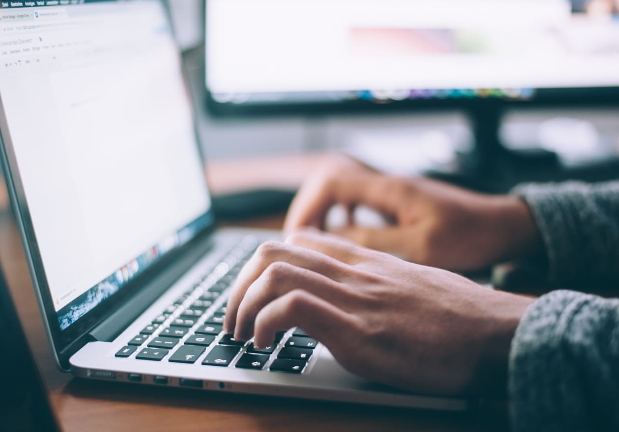 Close up of hands typing on a computer