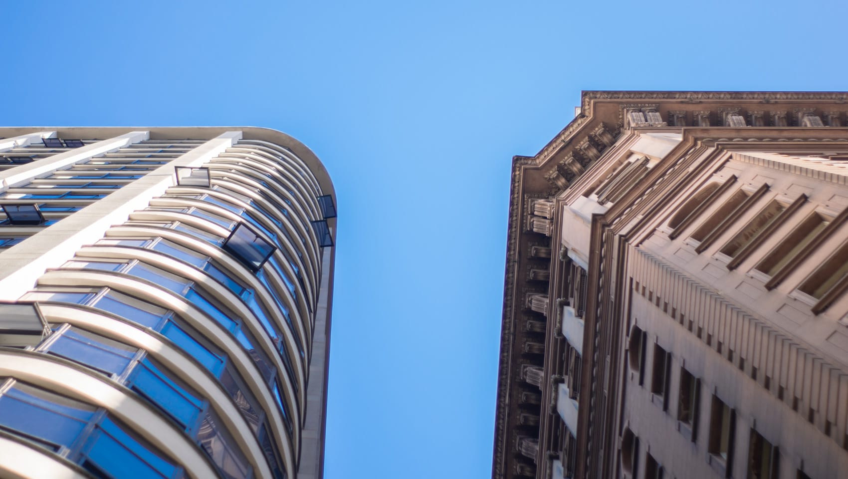 Looking up towards two tall buildings