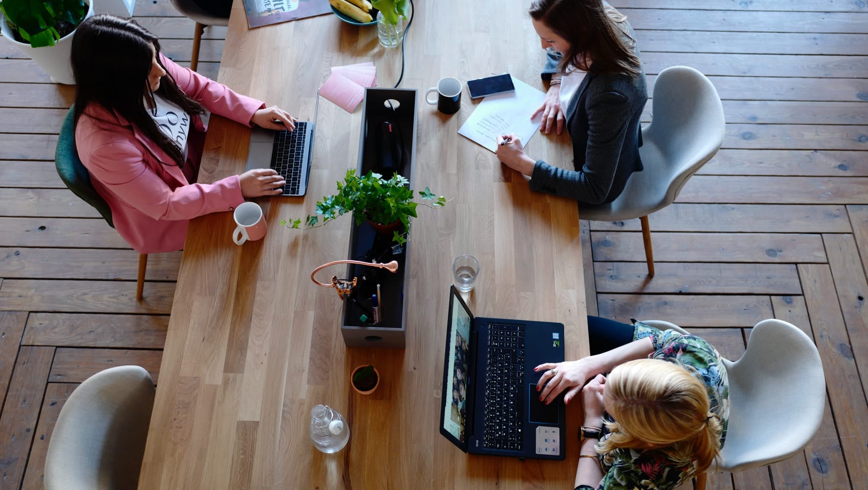 Three people working in a WeWork space